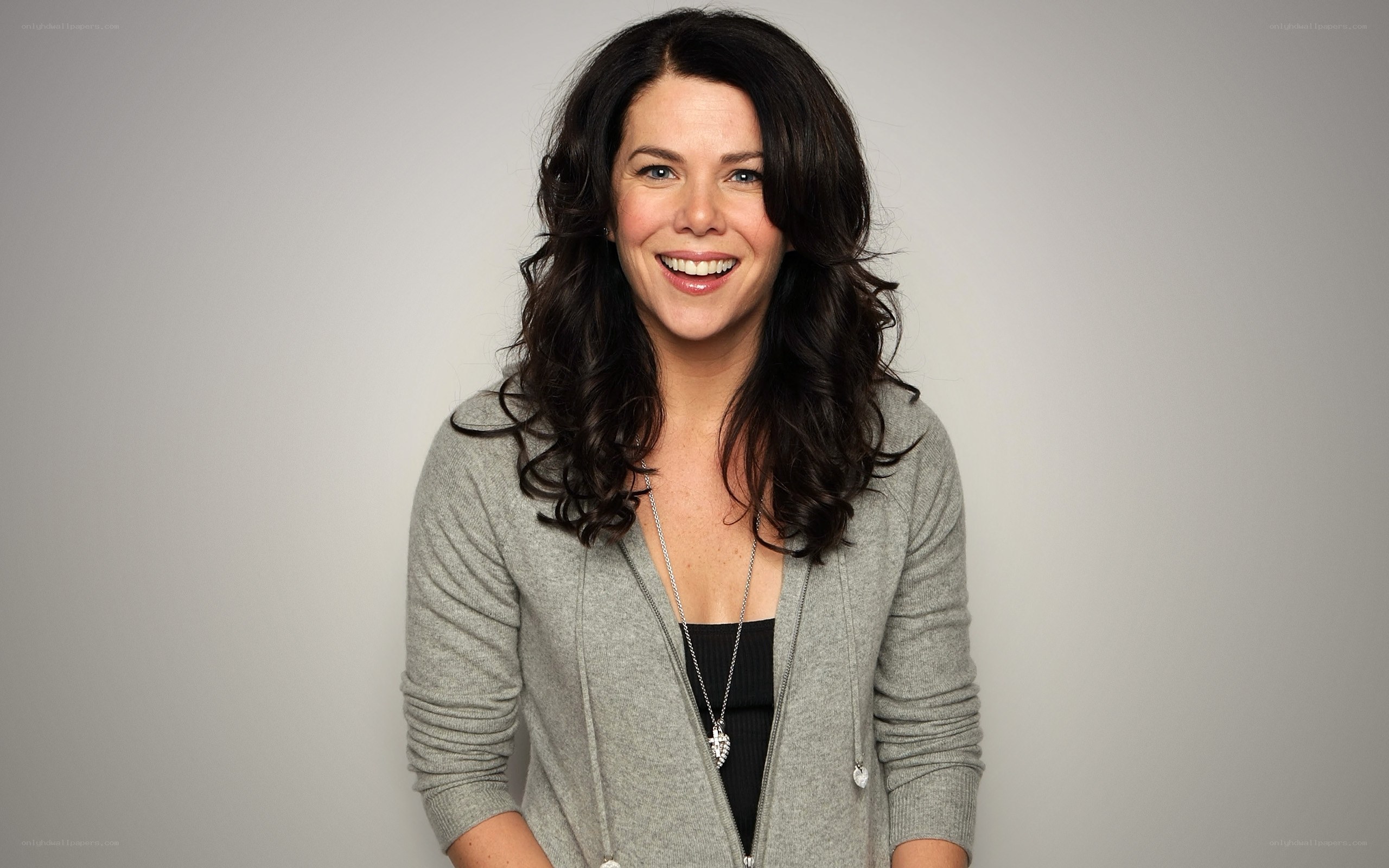 woman smiling in gray cardigan
