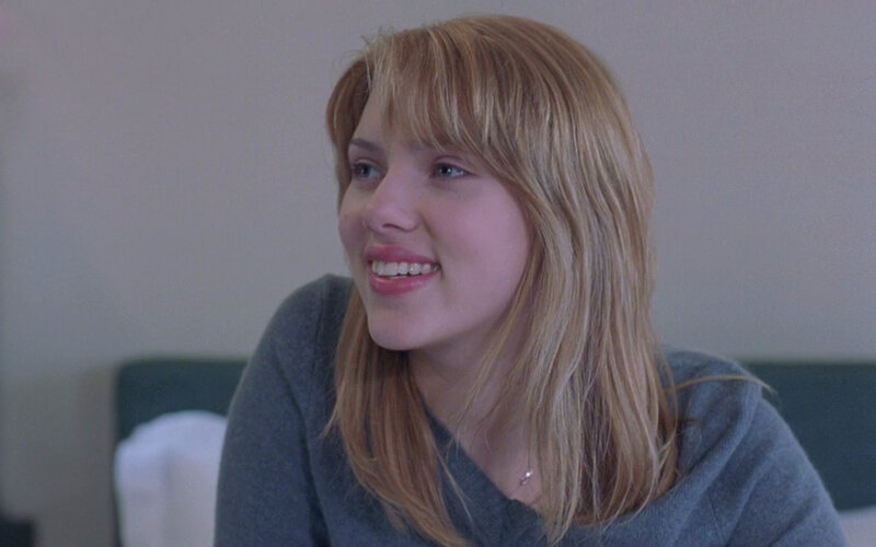 woman smiling in gray sweater