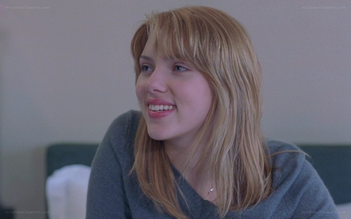 woman smiling in gray sweater