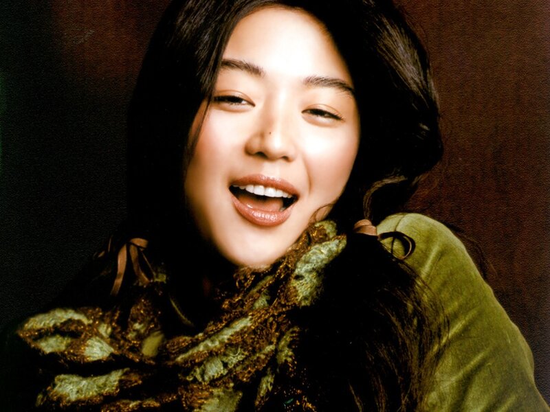 woman smiling in green scarf
