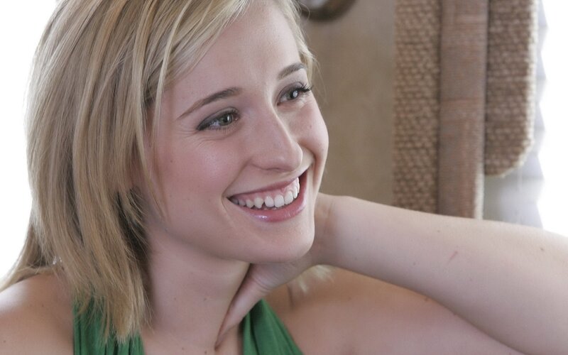 woman smiling in green top