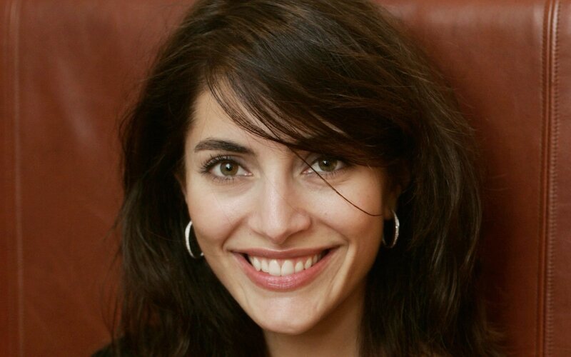 woman smiling in leather chair
