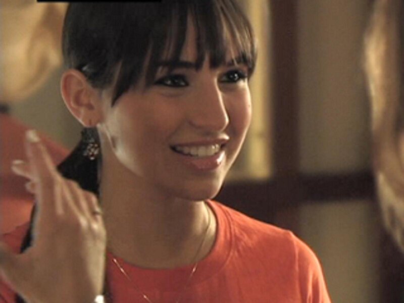 woman smiling in orange shirt