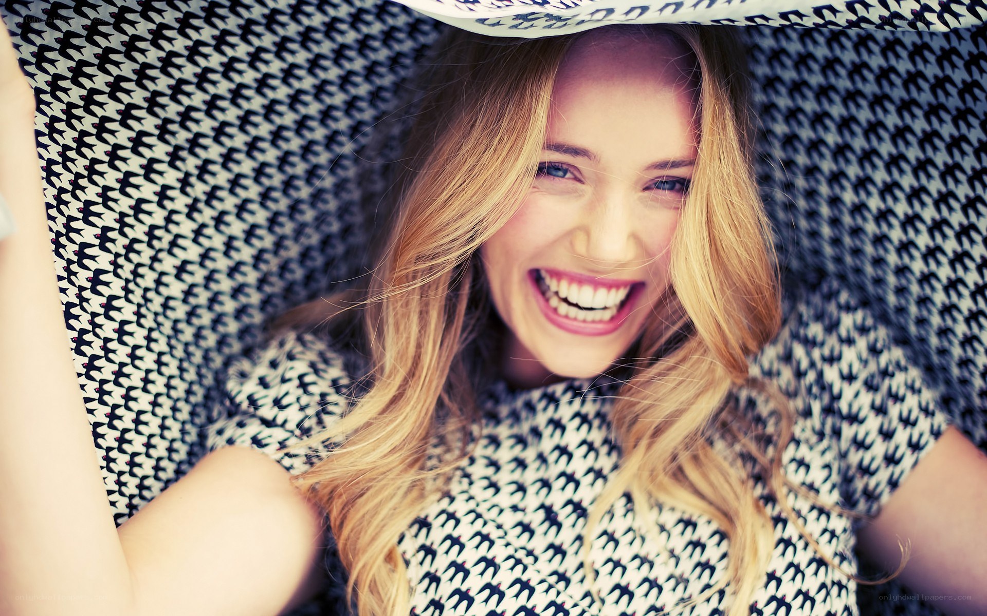 woman smiling in patterned chair