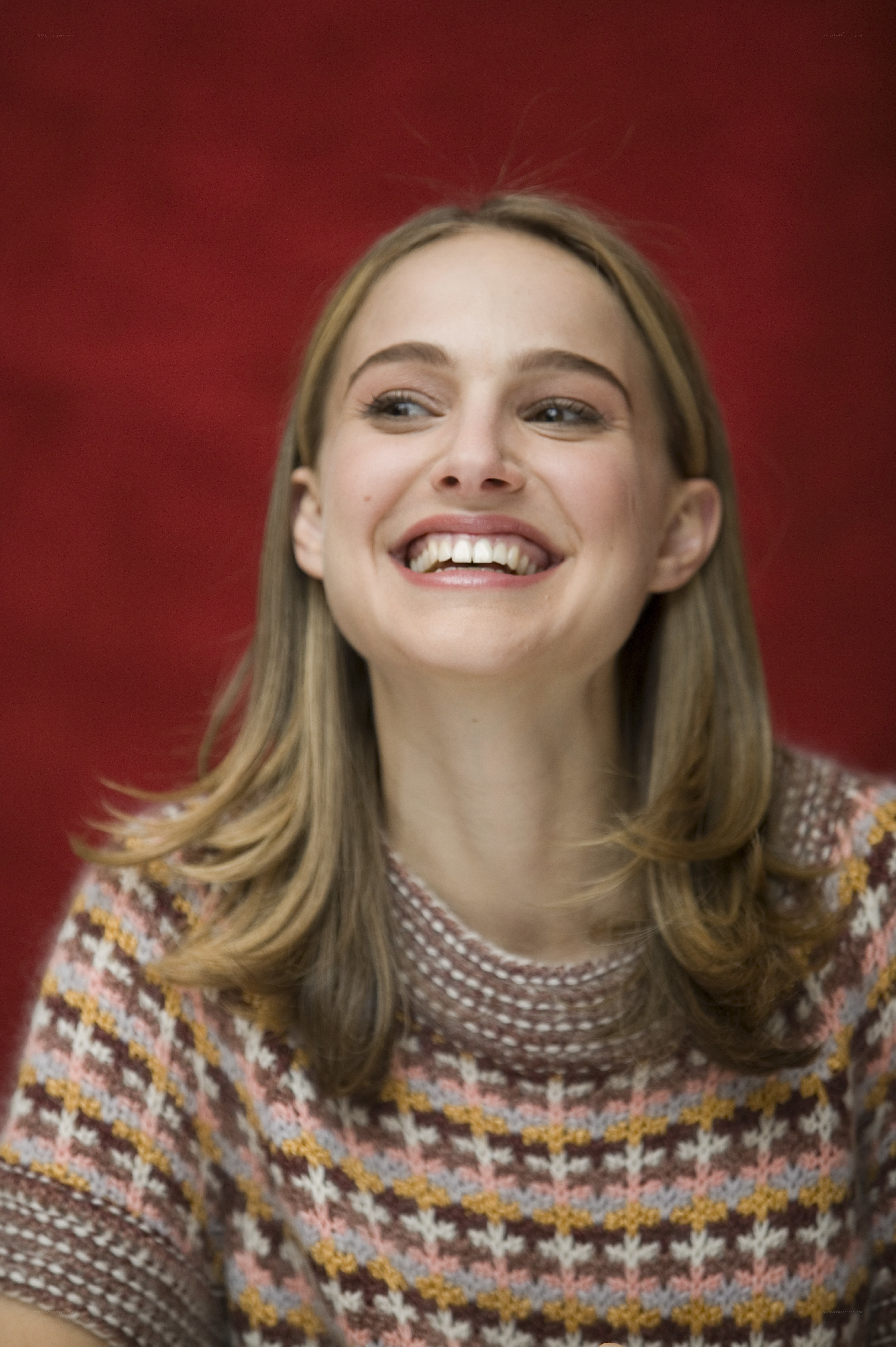 woman smiling in patterned sweater