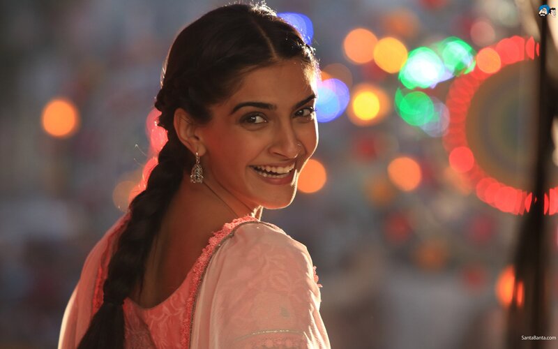 woman smiling in pink sari