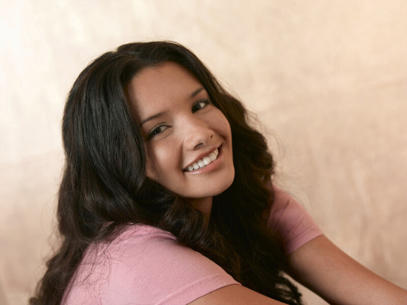 woman smiling in pink shirt