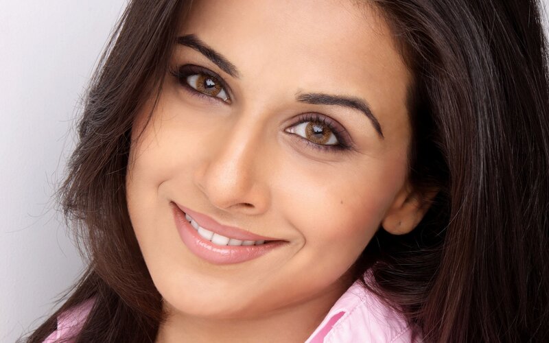woman smiling in pink shirt