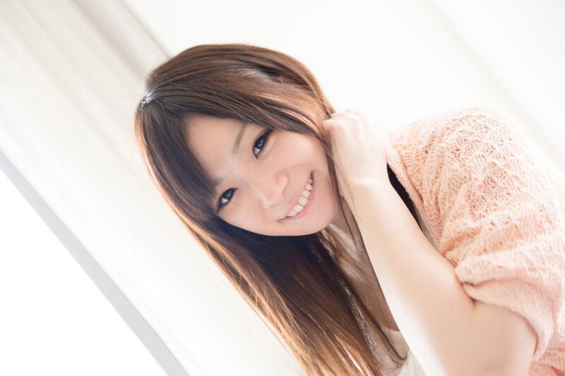 woman smiling in pink sweater