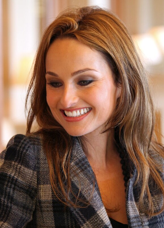 woman smiling in plaid jacket