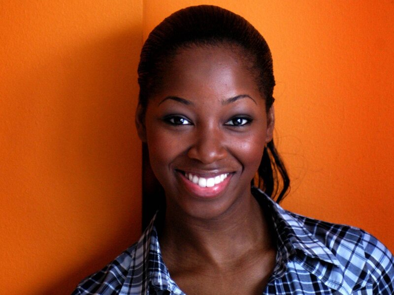 woman smiling in plaid shirt