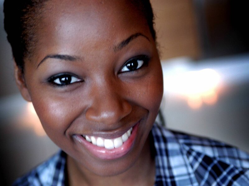 woman smiling in plaid shirt