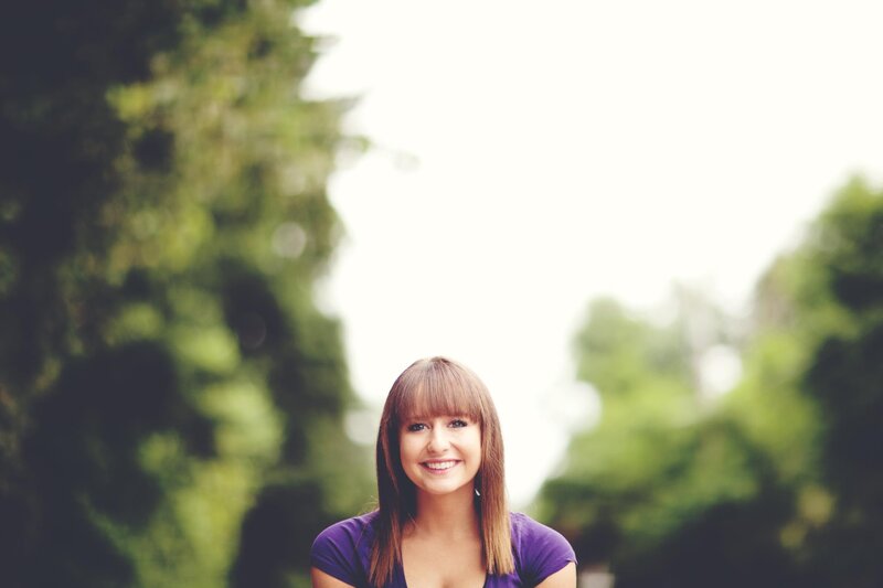 woman smiling in purple shirt