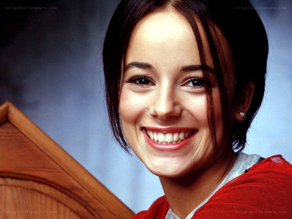woman smiling in red sweater