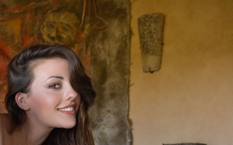 woman smiling in rustic room