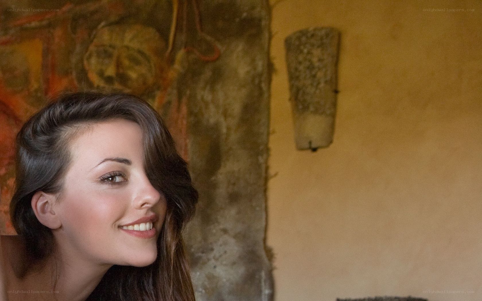 woman smiling in rustic room