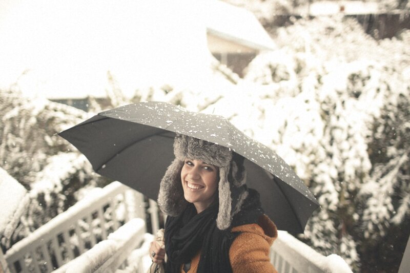 woman smiling in snowstorm