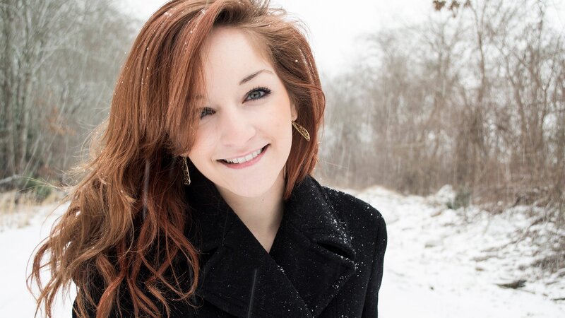 woman smiling in snowy forest
