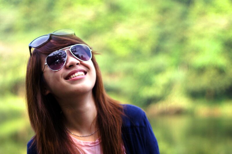 woman smiling in sunglasses
