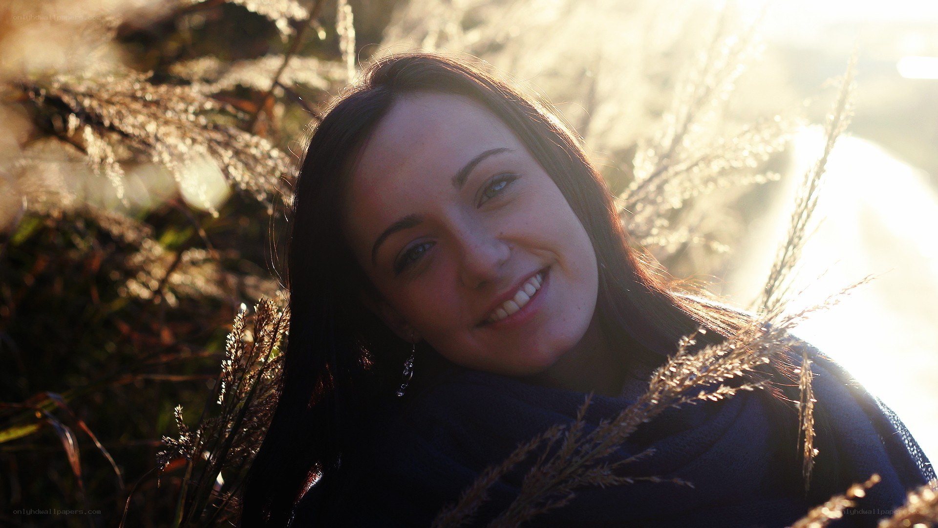 woman smiling in sunlit grass