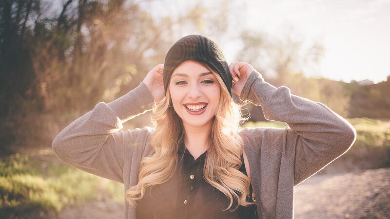 woman smiling in sunlit park
