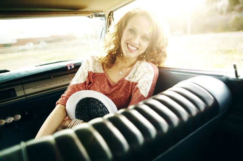 woman smiling in vintage car