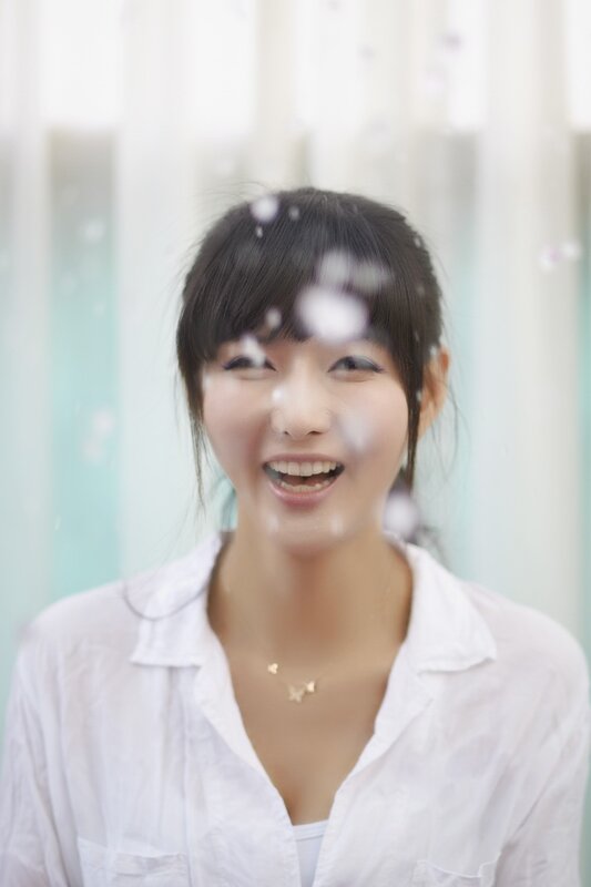 woman smiling in white shirt