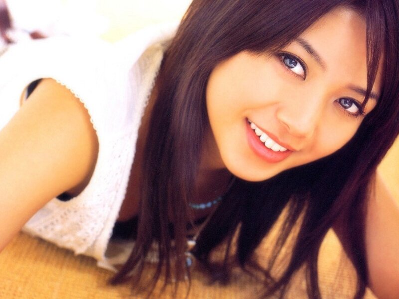 woman smiling in white top