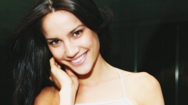 woman smiling in white top