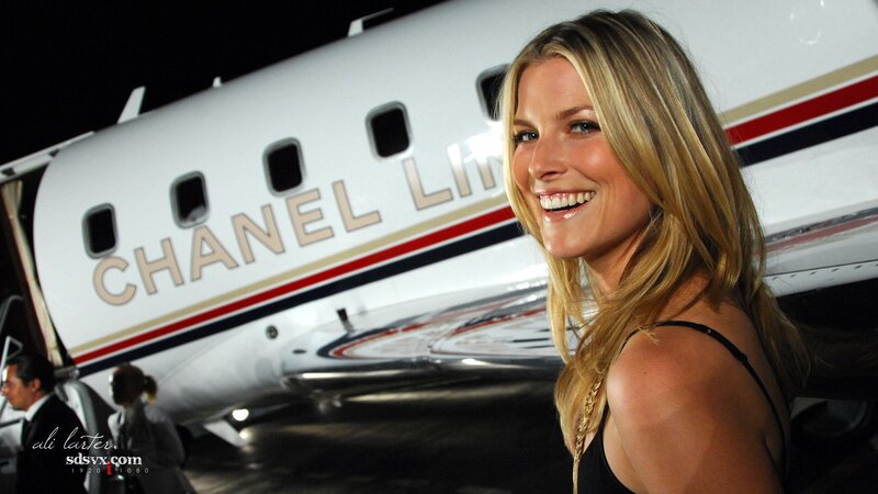 woman smiling near private jet