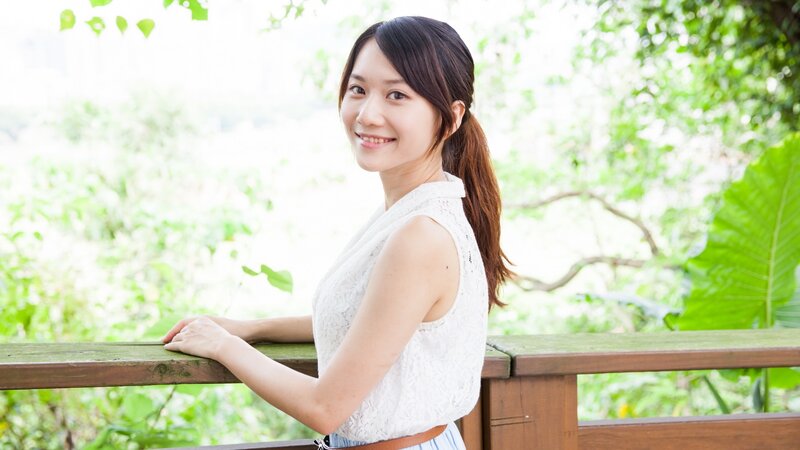 woman smiling on a balcony