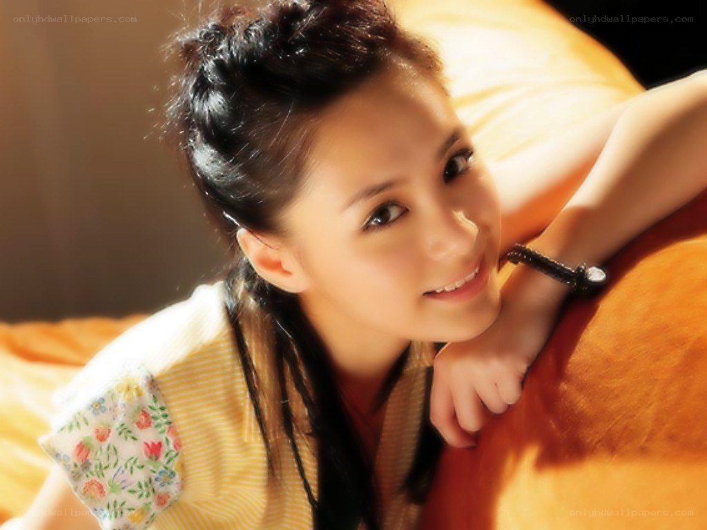 woman smiling on a bed