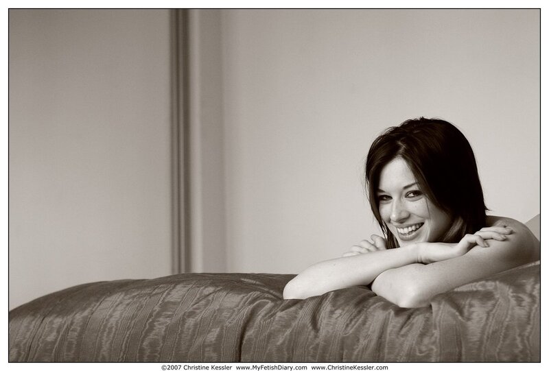 woman smiling on a bed