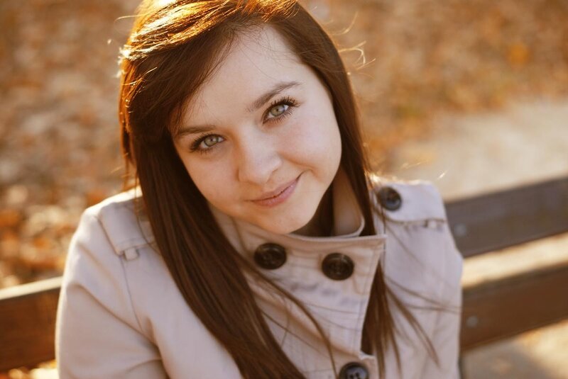 woman smiling on a bench
