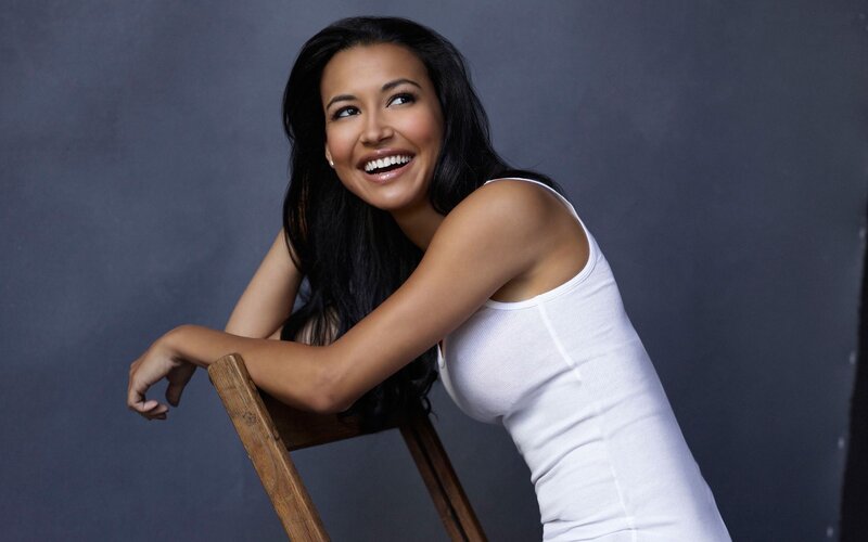 woman smiling on a chair
