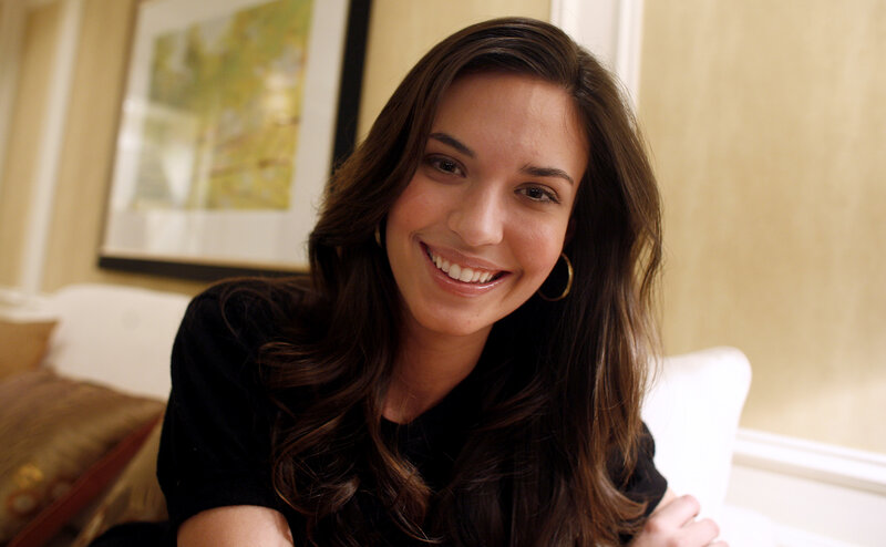 woman smiling on a couch