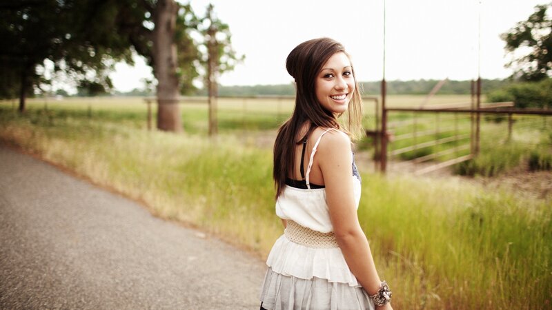 woman smiling on a country road