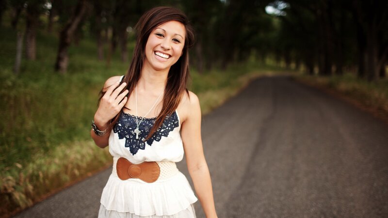 woman smiling on a country road