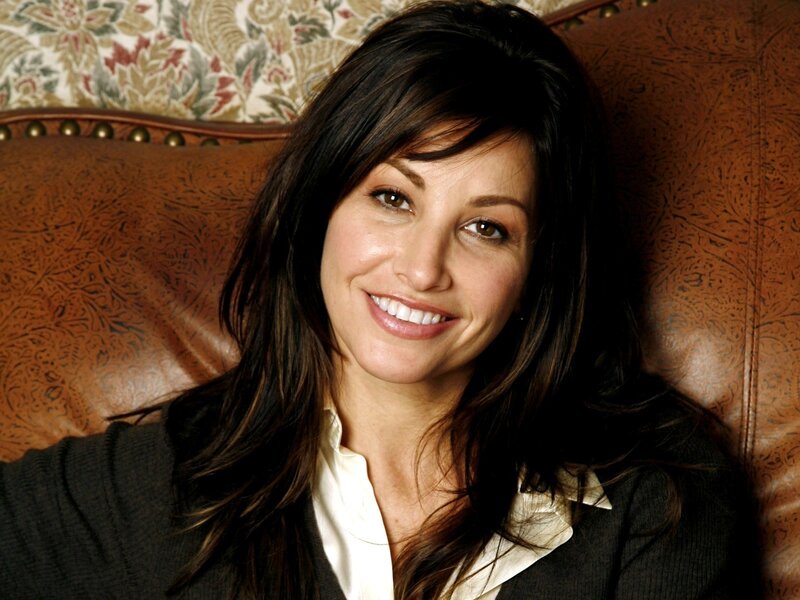 woman smiling on a leather couch