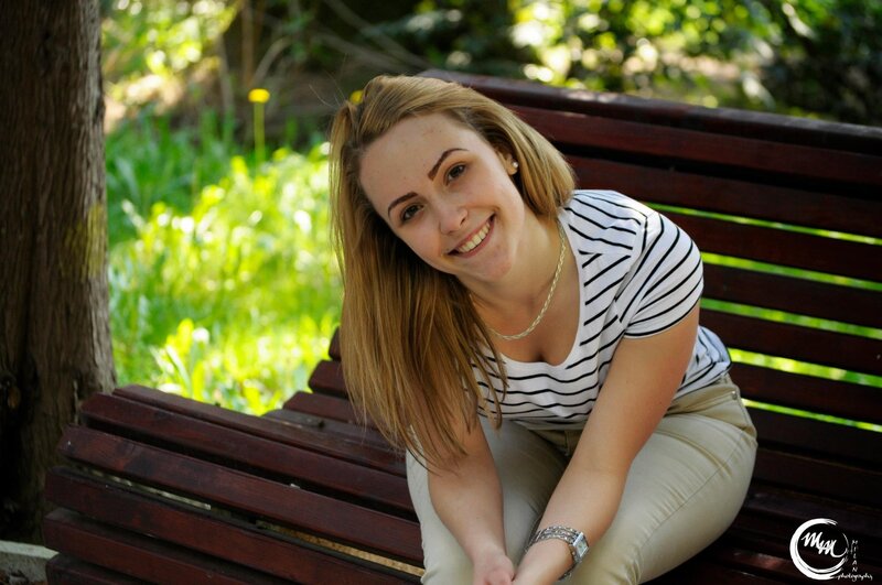 woman smiling on a park bench
