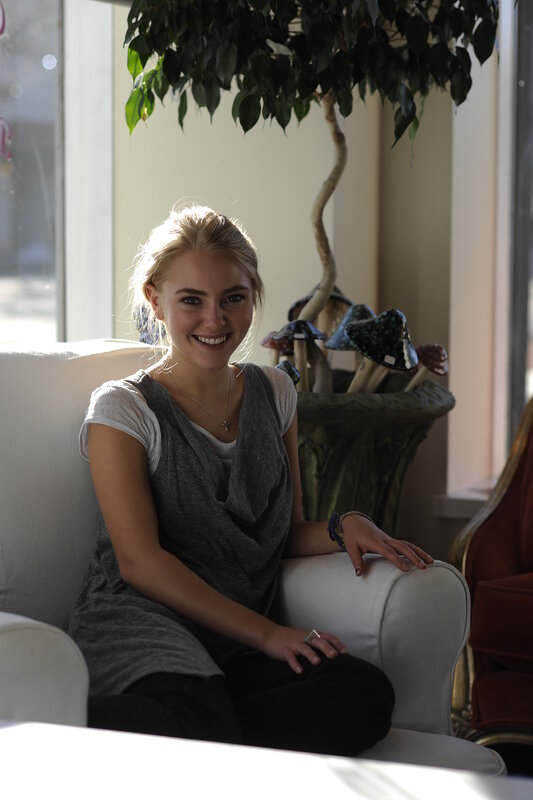 Woman smiling on a white couch