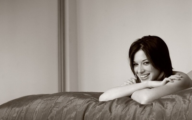 woman smiling on bed