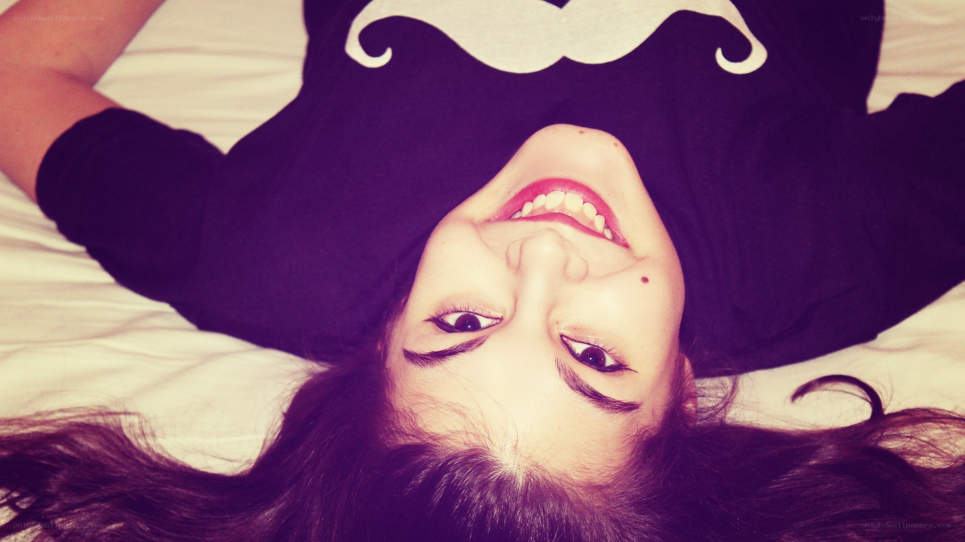 woman smiling on bed