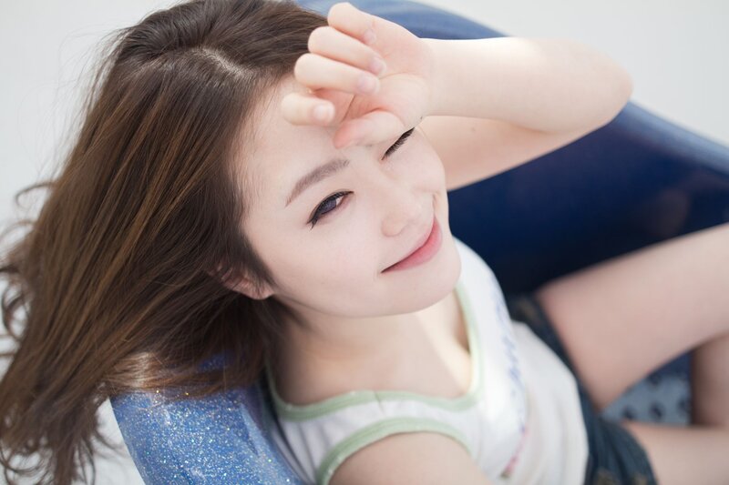 woman smiling on blue chair