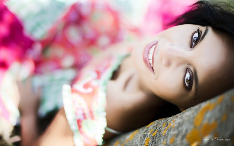 woman smiling on colorful blanket