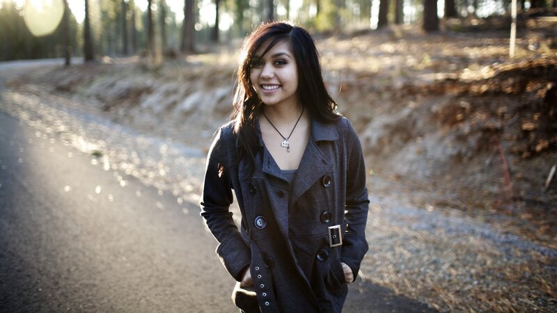 woman smiling on forest path