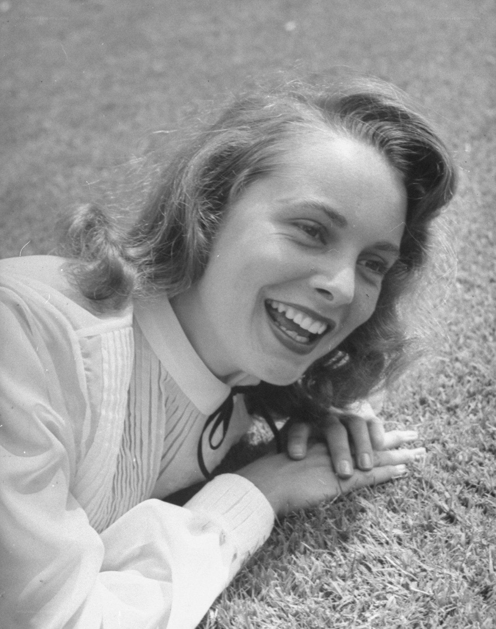 woman smiling on grass
