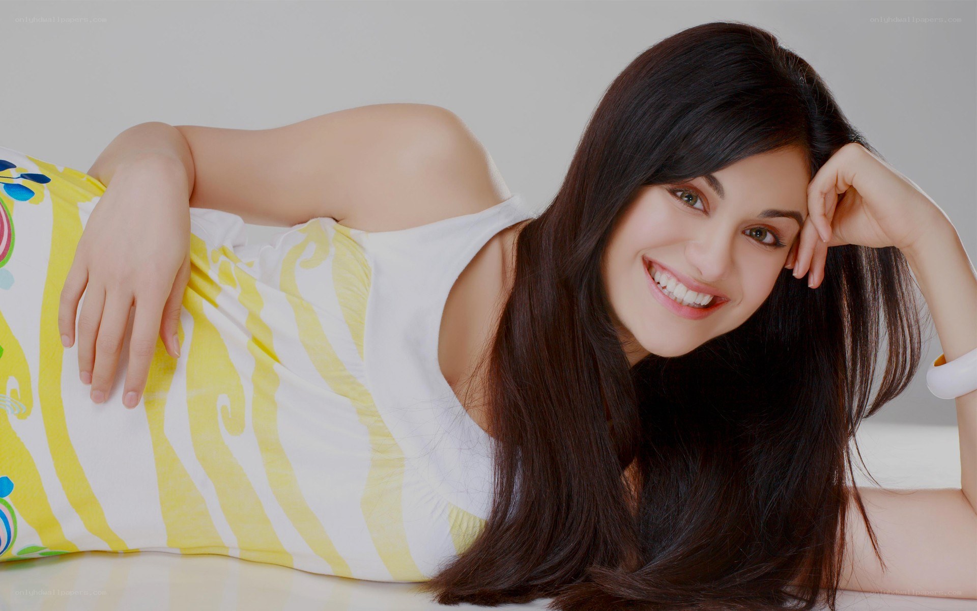 woman smiling on patterned pillow