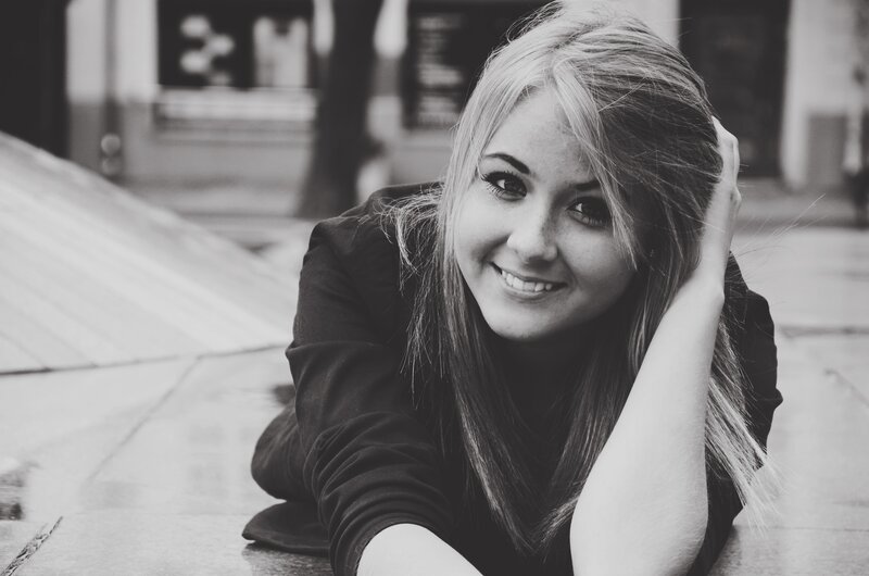 woman smiling on pavement