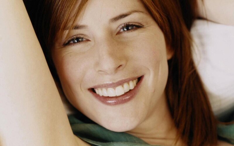 Woman Smiling on Pillow — Brown